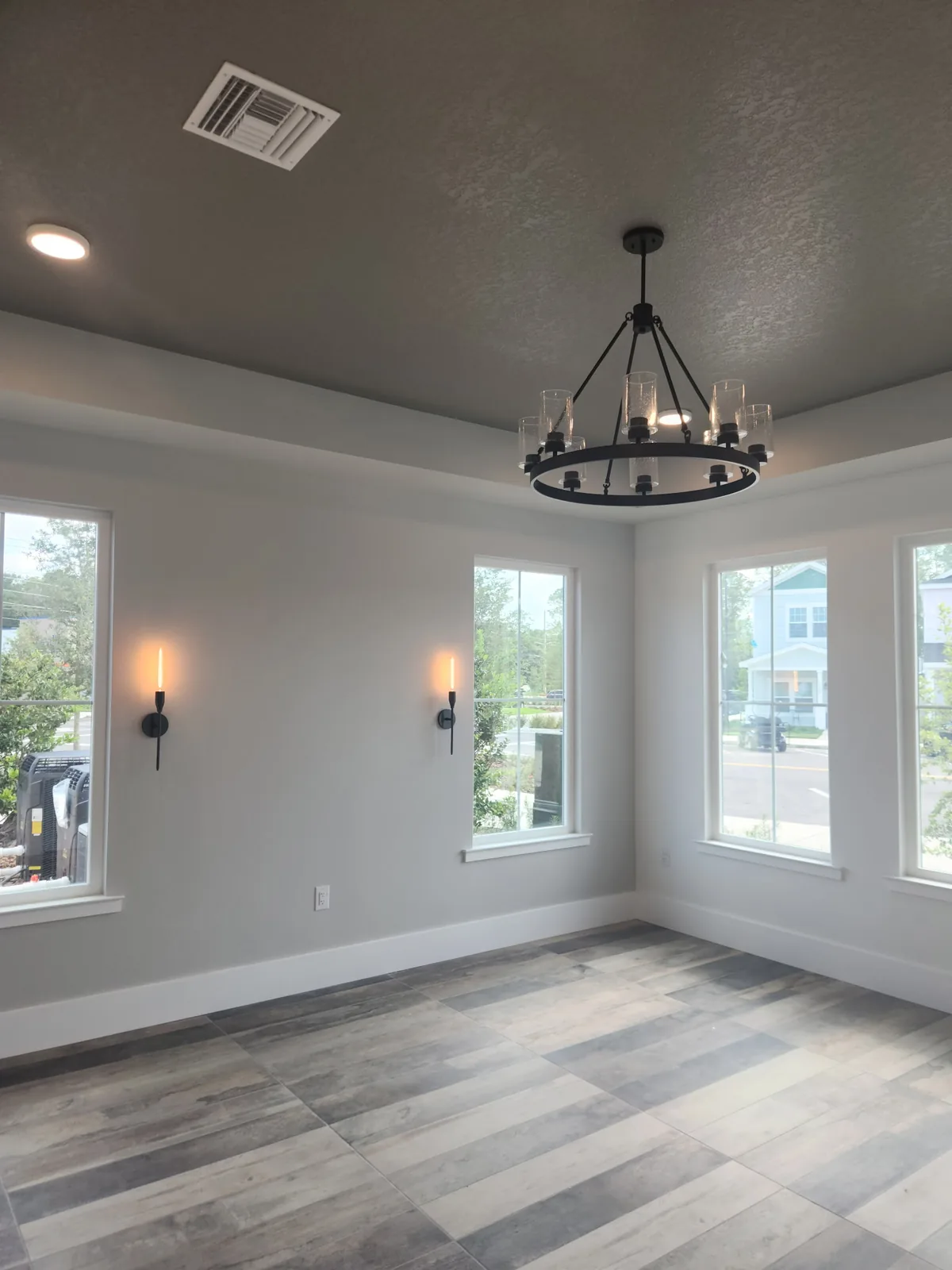 Dining room chandelier hung over a vaulted ceiling