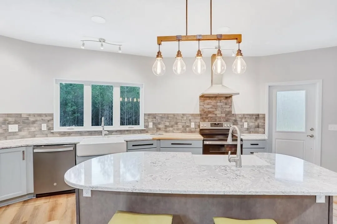 Remodeled kitchen island with pendant lighting